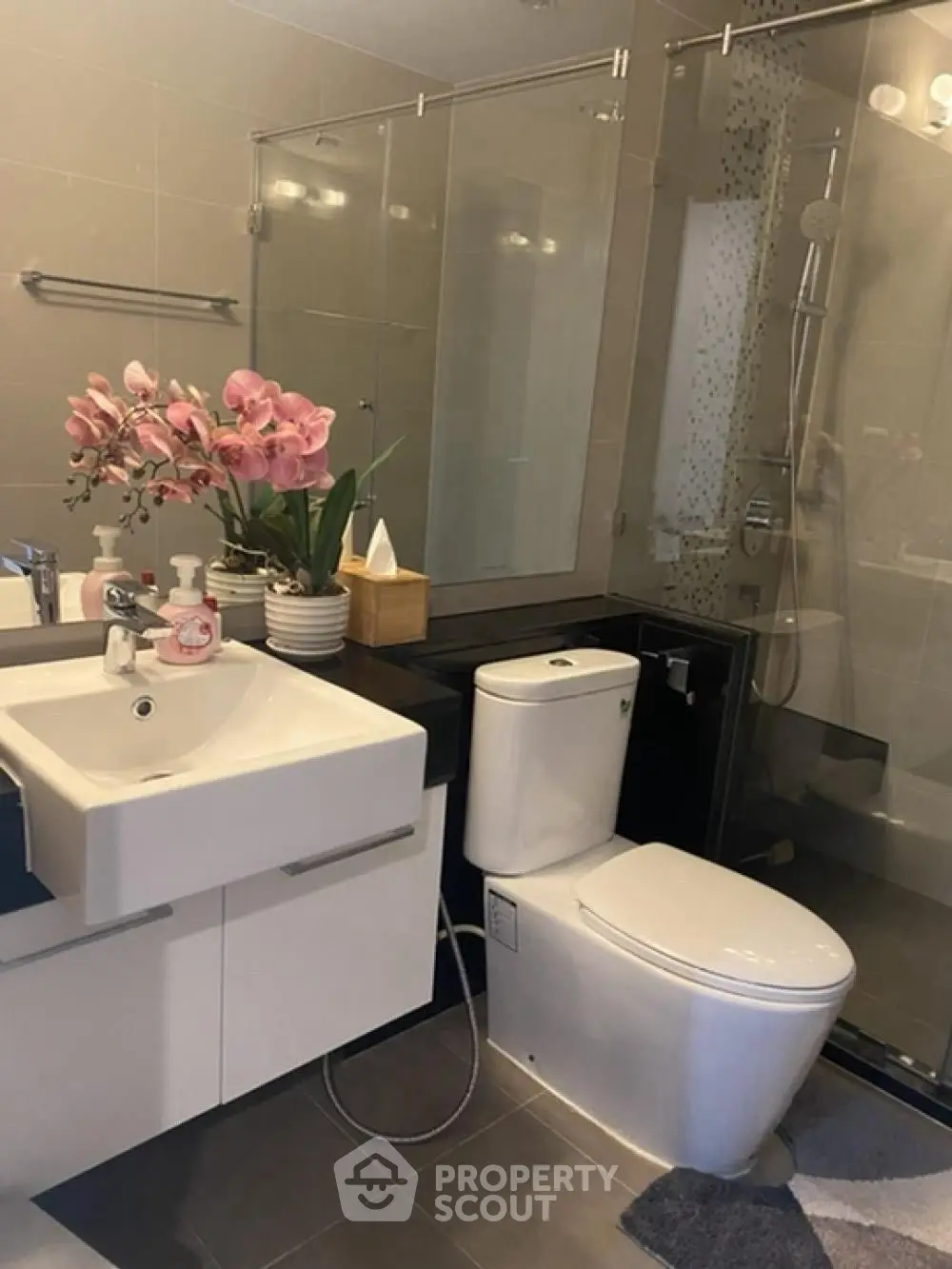 Modern bathroom with sleek fixtures and glass shower enclosure