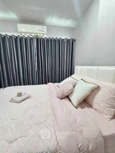 Cozy bedroom with elegant decor and soft pink bedding, perfect for relaxation and comfort.