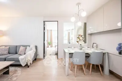 Modern open-plan living and dining area with stylish decor and natural light.