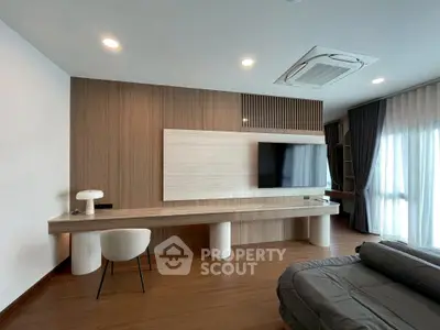 Modern living room with sleek wooden paneling and stylish furniture