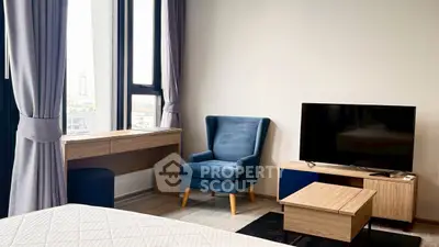 Modern bedroom with stylish furniture and large windows offering city views.