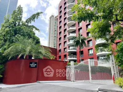 Stunning red brick apartment building with lush greenery and secure gated entrance.