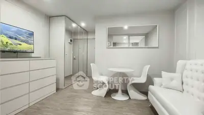 Modern minimalist living room with sleek white furniture and mirrored wardrobe