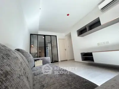 Modern living room with sleek design and cozy gray sofa