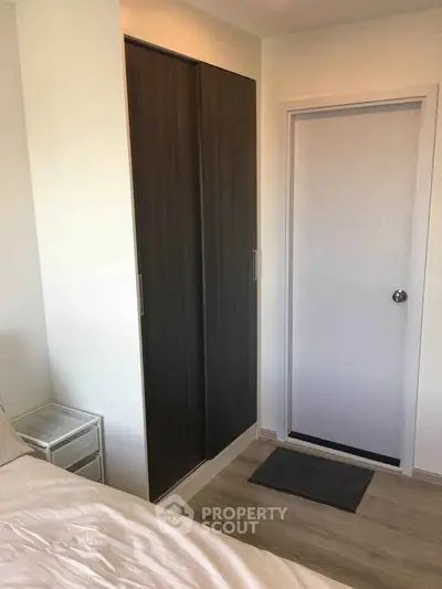 Modern bedroom with sleek wardrobe and minimalist decor