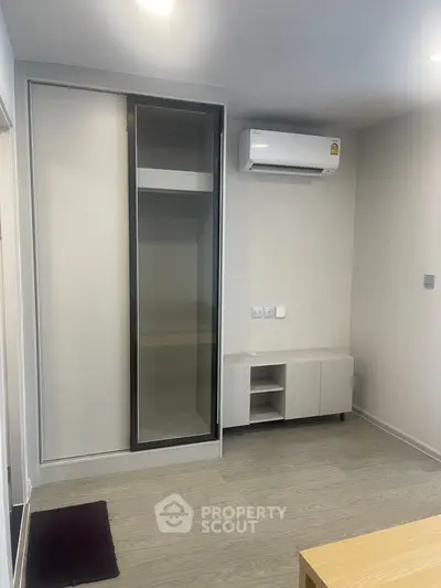 Modern living room with sleek air conditioning and built-in storage, perfect for contemporary urban living.