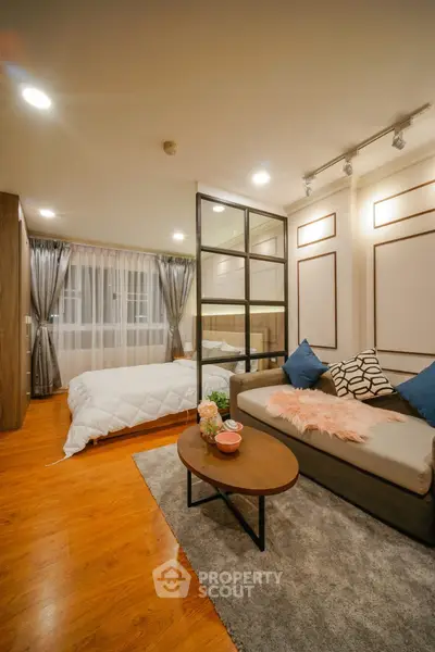 Modern studio apartment with cozy living area and stylish bedroom