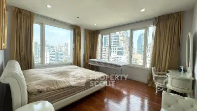 Luxurious bedroom with panoramic city views and elegant furnishings