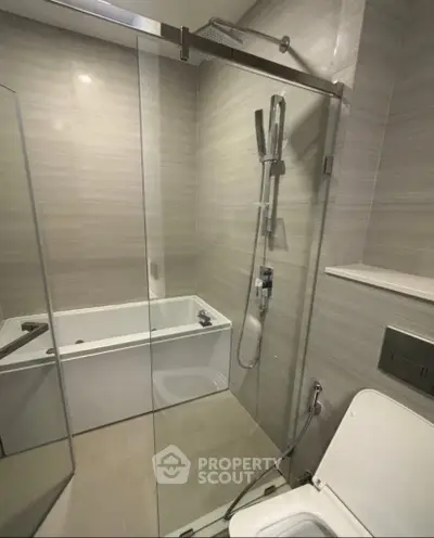 Modern bathroom with glass shower and bathtub in sleek design