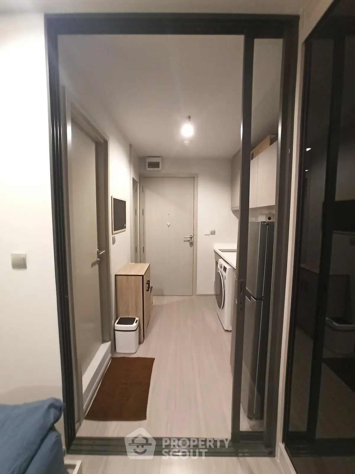 Modern apartment hallway with washing machine and sleek storage solutions