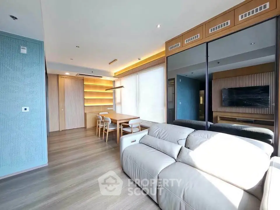 Modern living room with sleek design, large sofa, and stylish dining area.