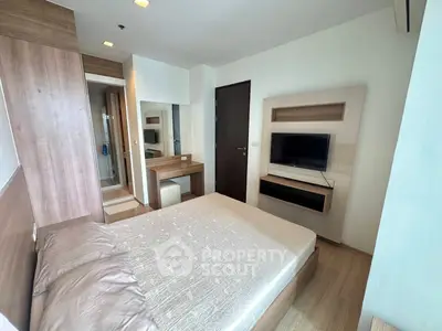 Modern bedroom with wooden accents and wall-mounted TV in a stylish apartment.