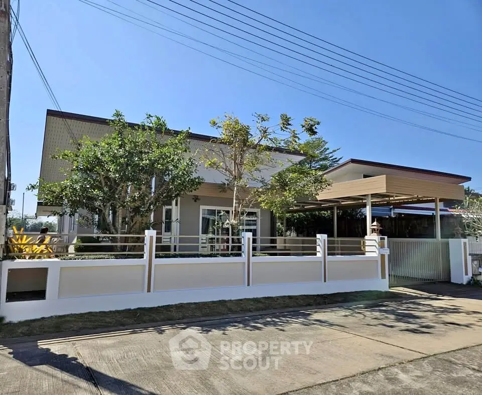 Modern single-story house with lush garden and sleek fence design