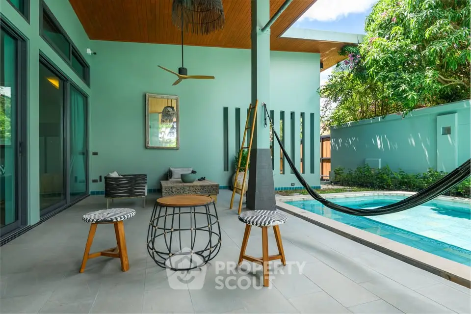 Luxurious outdoor patio with pool and modern seating in tropical setting