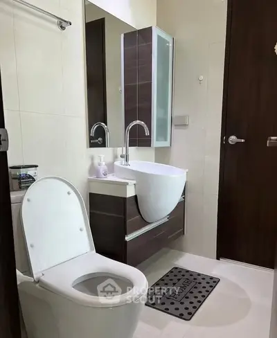 Modern bathroom with sleek fixtures and stylish vanity in a contemporary home.