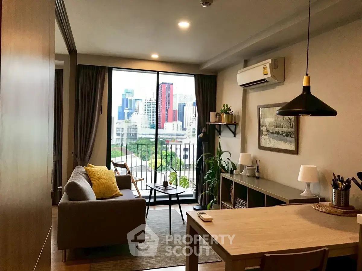Modern living room with city view, stylish decor, and cozy ambiance in urban apartment.