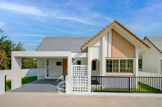 Charming modern house with unique architectural design and spacious driveway in a serene neighborhood.