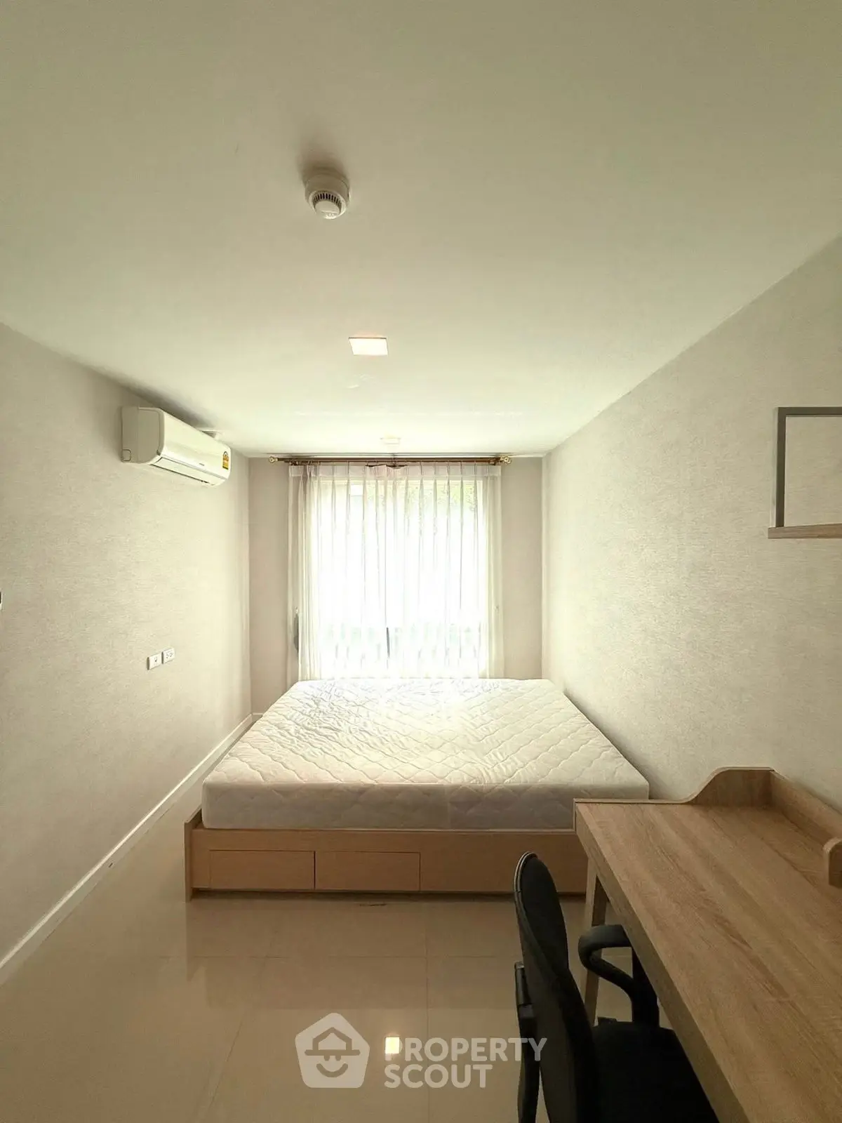 Bright minimalist bedroom with large window and modern furniture