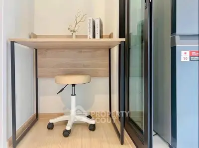 Compact study nook with wooden desk and swivel chair, perfect for small spaces.