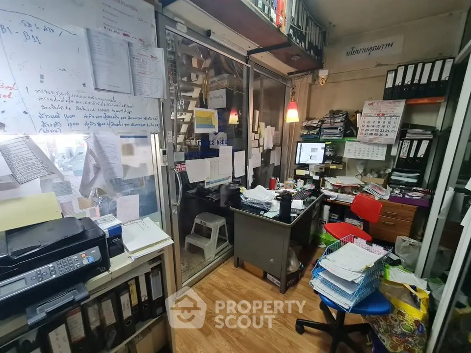Cozy home office with organized shelves and modern decor, perfect for productivity and comfort.