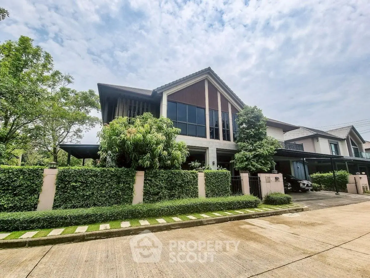 Stunning modern house with lush greenery and spacious driveway