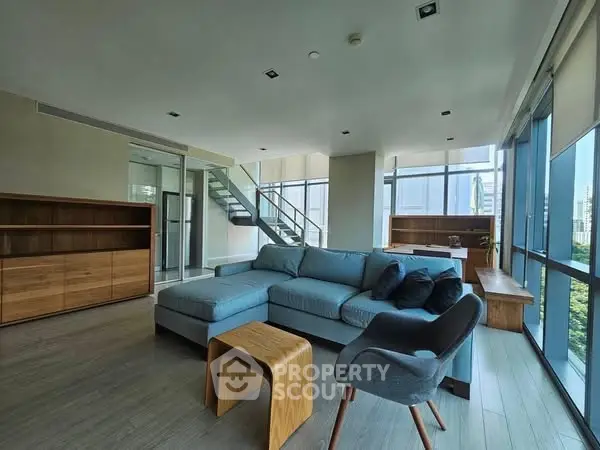 Spacious modern living room with large windows and stylish furniture