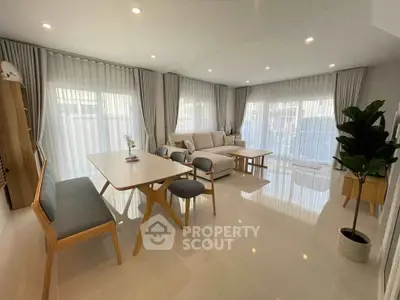 Spacious modern living room with elegant furniture and large windows for natural light.
