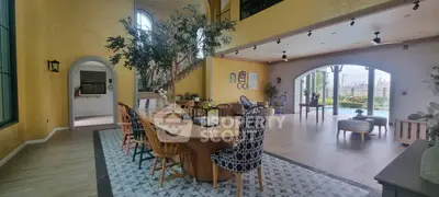 Spacious living room with elegant decor and poolside view, perfect for luxury living.