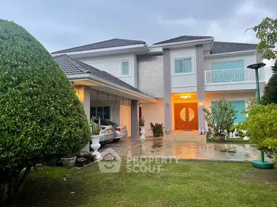 Stunning two-story house with modern design, spacious driveway, and lush garden, perfect for family living.