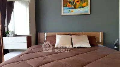 Modern bedroom with stylish decor and cozy bedding, featuring a large window and elegant wall art.