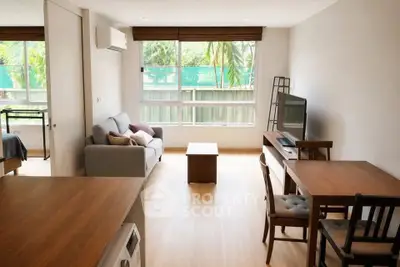 Bright and airy living room with modern furniture and large window view.