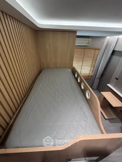 Modern minimalist bedroom with unique wooden bed design and ambient lighting.