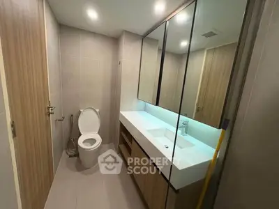Modern bathroom with sleek design and spacious vanity in a contemporary apartment.
