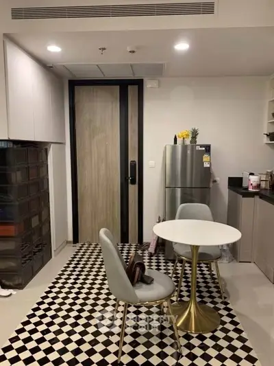 Modern kitchen with stylish checkered floor and compact dining area