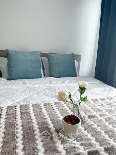 Cozy bedroom with elegant decor and soft lighting, featuring a stylish bed and decorative pillows.
