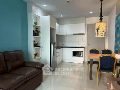 Modern apartment interior with cozy living area and sleek kitchen design.