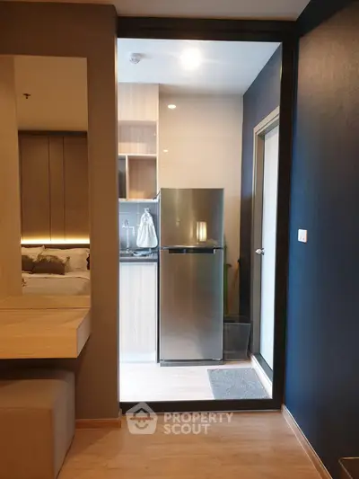 Modern apartment interior with sleek kitchen and cozy bedroom view