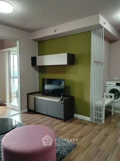 Modern living room with stylish decor and washing machine in open layout apartment