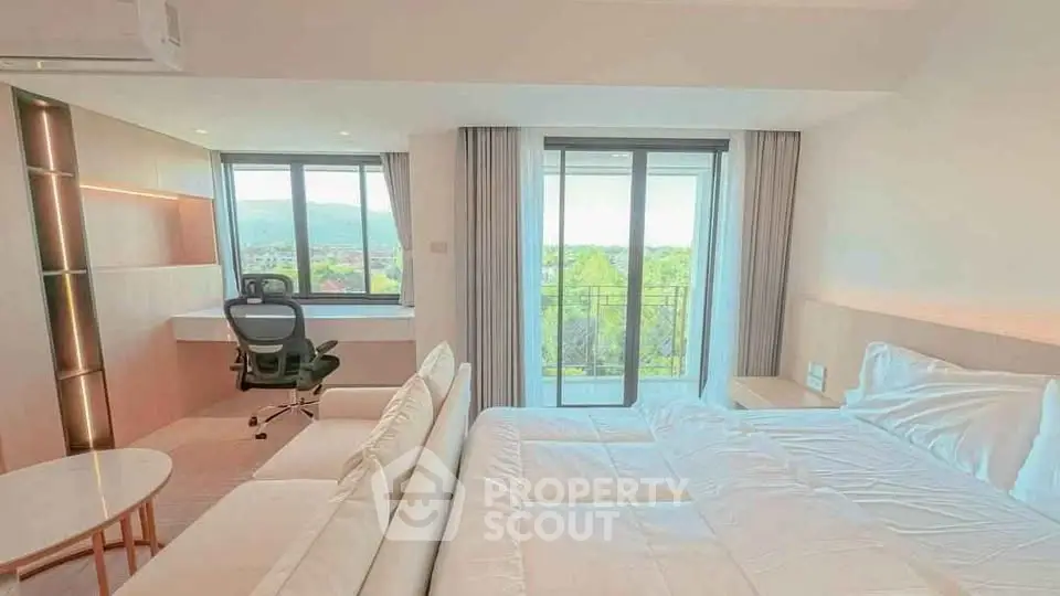 Modern bedroom with scenic view and cozy workspace