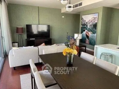 Elegant living room with modern decor and open layout, featuring a stylish dining area and cozy seating.