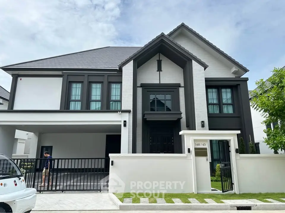 Stunning modern two-story house with sleek design and spacious driveway
