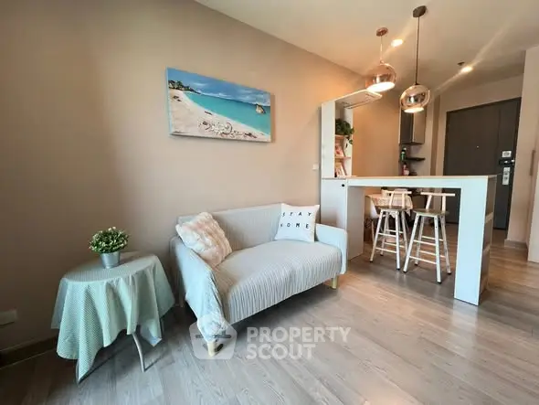 Modern living room with cozy sofa and stylish decor in open layout apartment.