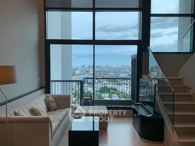 Spacious living room with stunning city view and modern interior design.