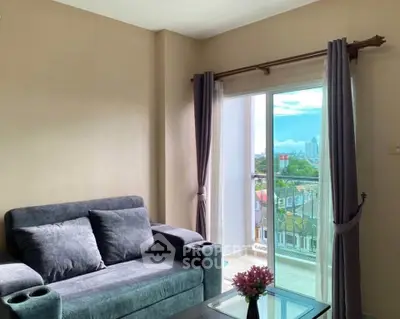 Modern living room with plush sofa and city view from balcony, perfect for urban living.