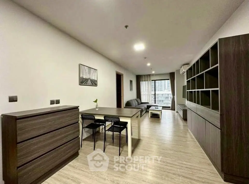 Spacious modern living room with sleek furniture and open layout in a stylish apartment.