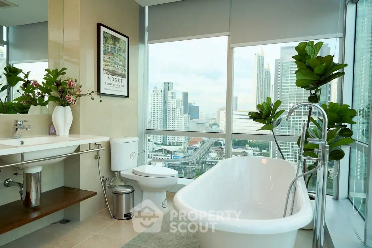 Luxurious bathroom with city view and elegant freestanding bathtub.