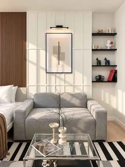 Stylish modern living room with gray sofa, glass coffee table, and elegant wall art.