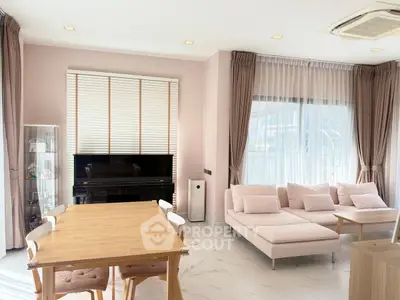 Elegant living room with piano and modern furniture, featuring large windows and soft pink decor.