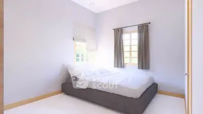 Cozy minimalist bedroom with natural light and modern decor