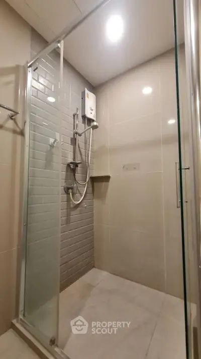 Modern bathroom with glass shower enclosure and sleek tile design